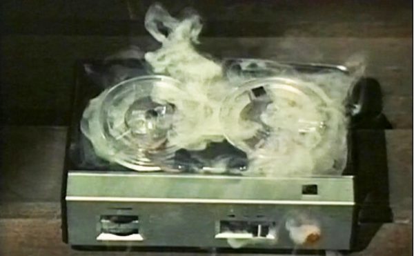 old fashioned tape recorder with smoke coming out of it