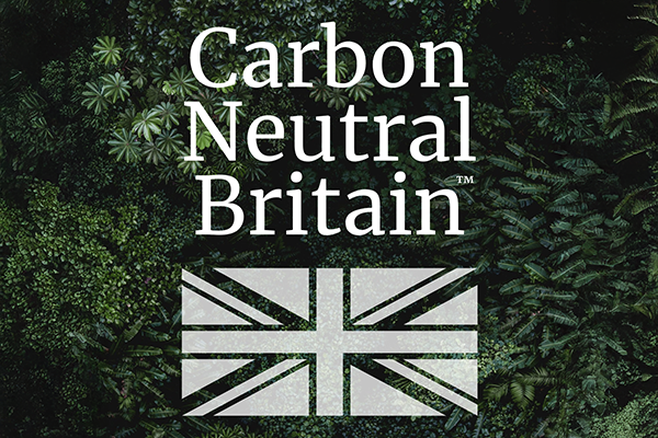 Carbon Neutral Britain logo with a background of dark green leaves
