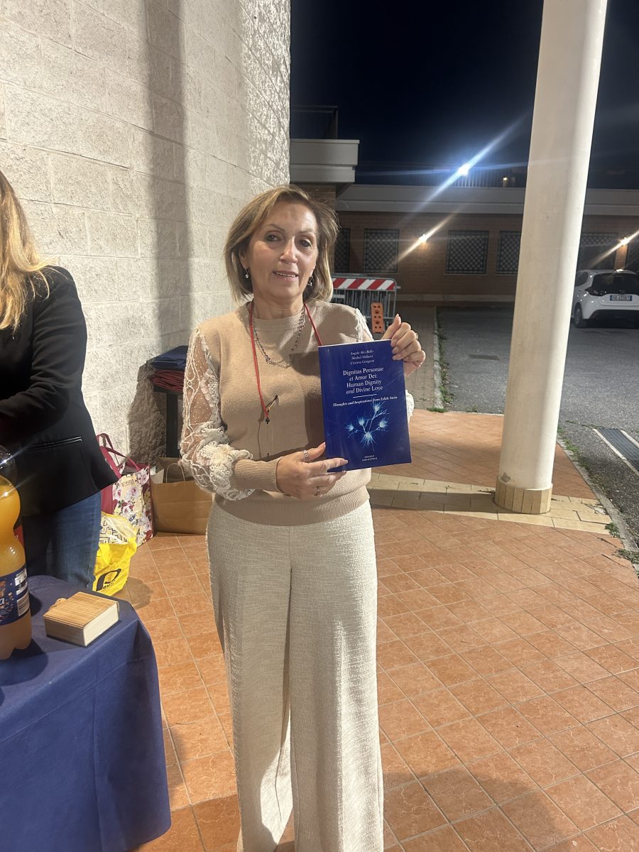 Cristina Gangemi holding a copy of her book.