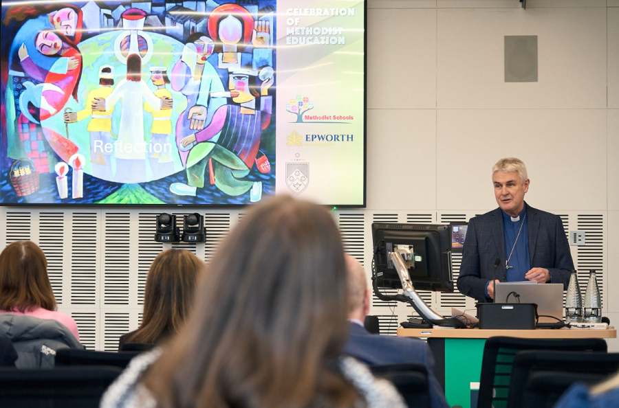 Reverend Richard Andrew provides opening devotions for the conference.