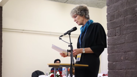 Sue Miller speaks at a community dinner