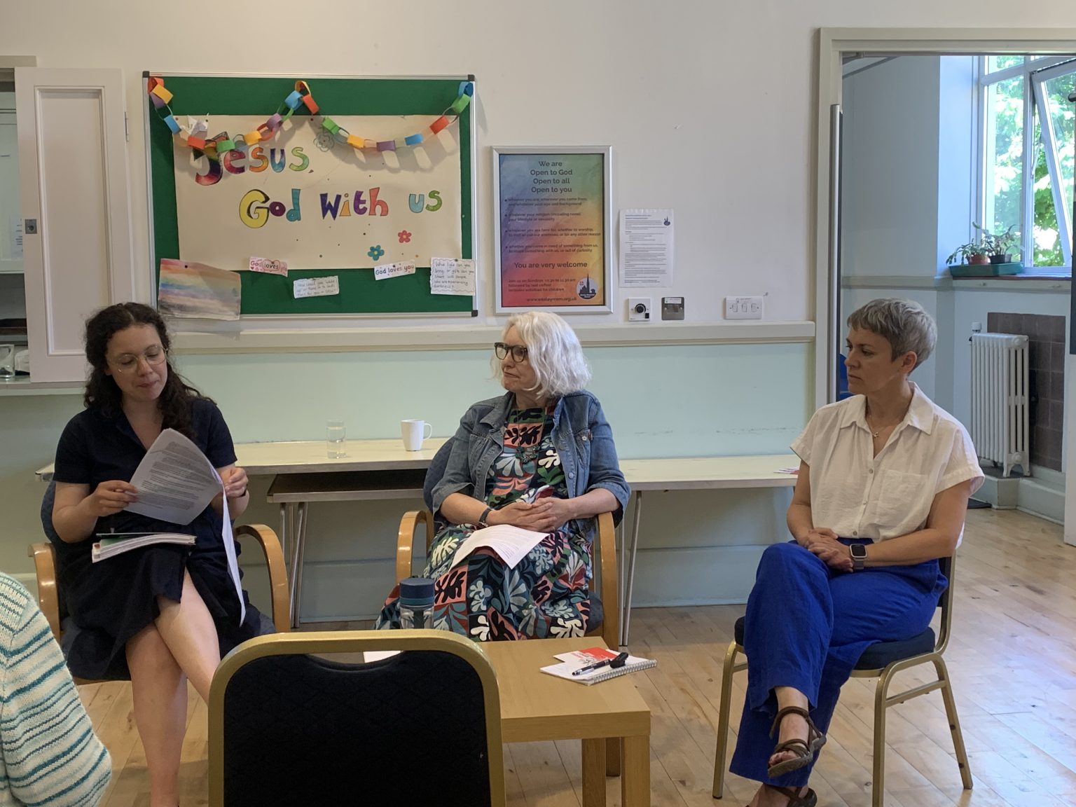 Three women seated in discussion