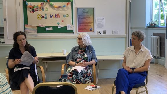Three women seated in discussion