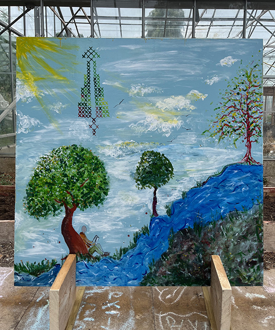 Large painted mural with sky, river and trees