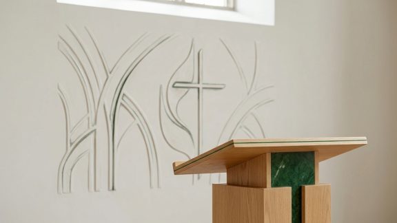 Image of pulpit with cross image behind on wall